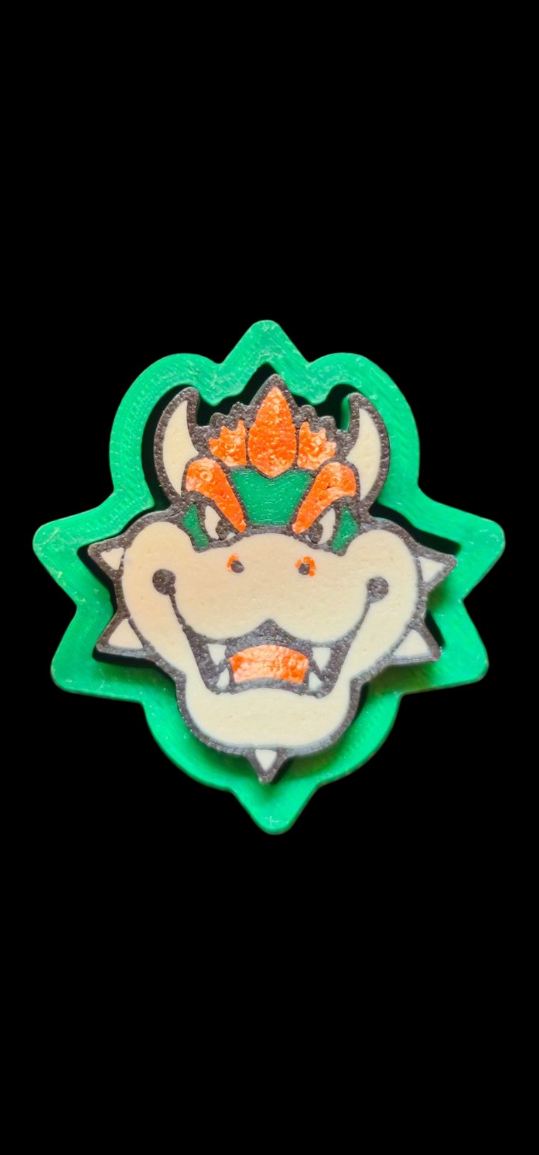 Bowser face fidget clicker with orange hair and horns on a green spiky frame