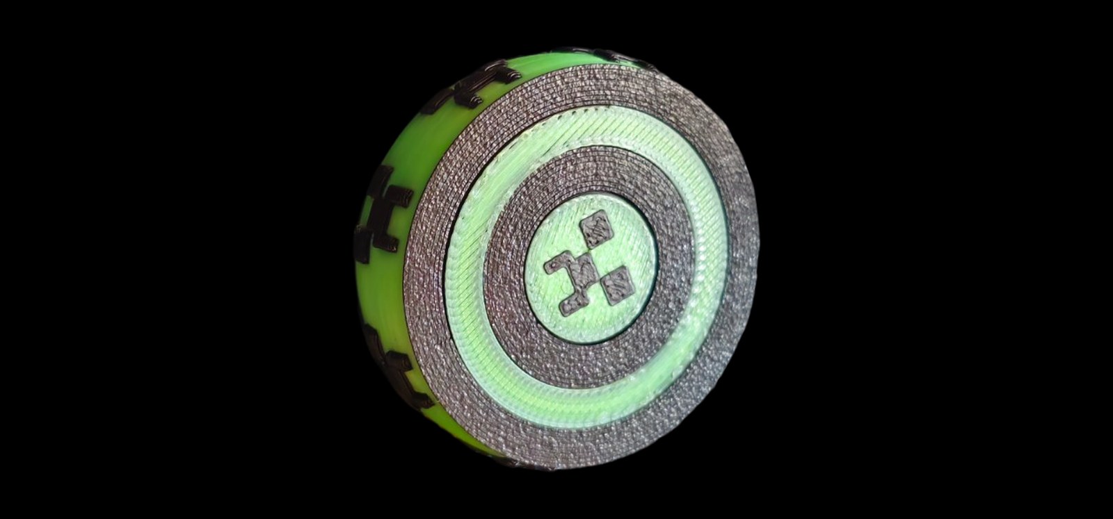 Round green and black Minecraft creeper fidget with spinning rings