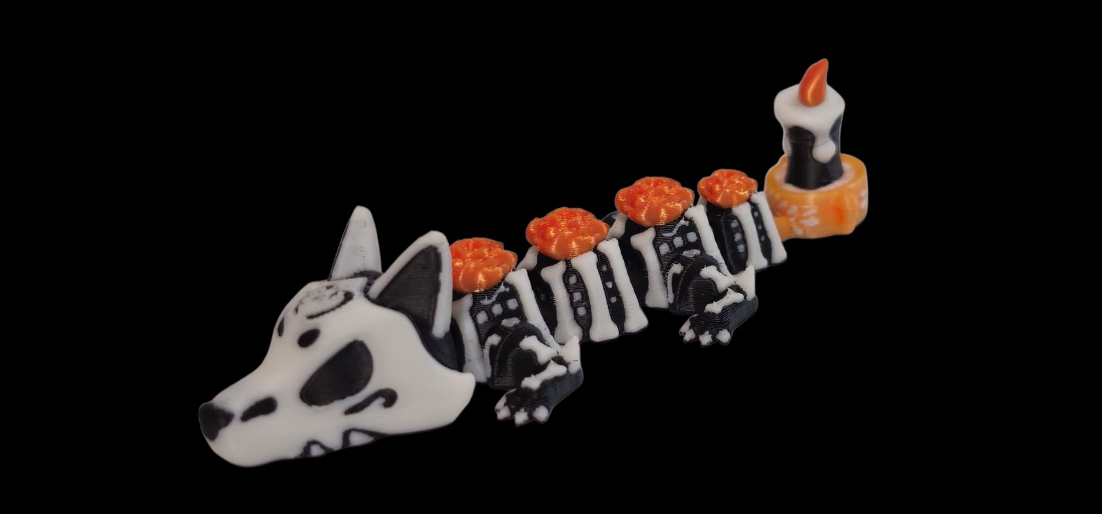 White and black skeleton dragon with orange marigolds down its back and a candle on its tail