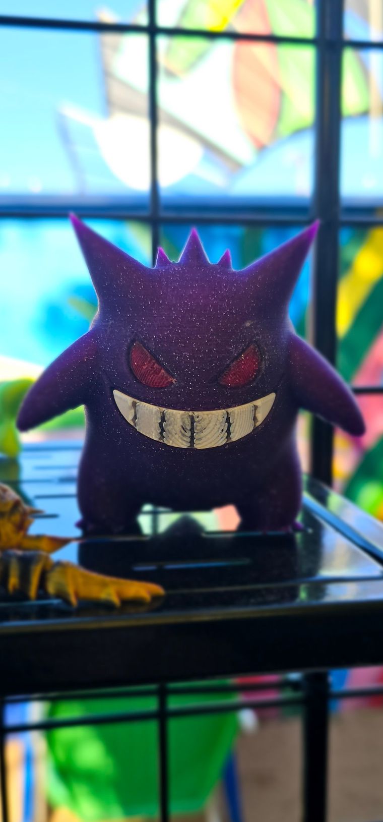 Large sparkly purple Gengar figure with red eyes and a wide grin
