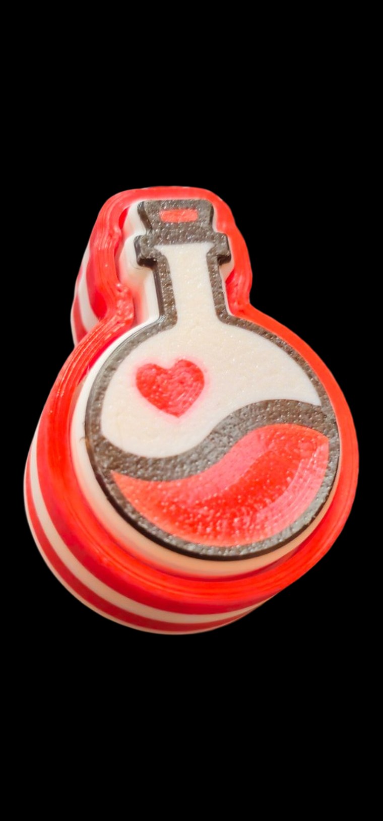 Red and white heart potion bottle fidget with a spinning center