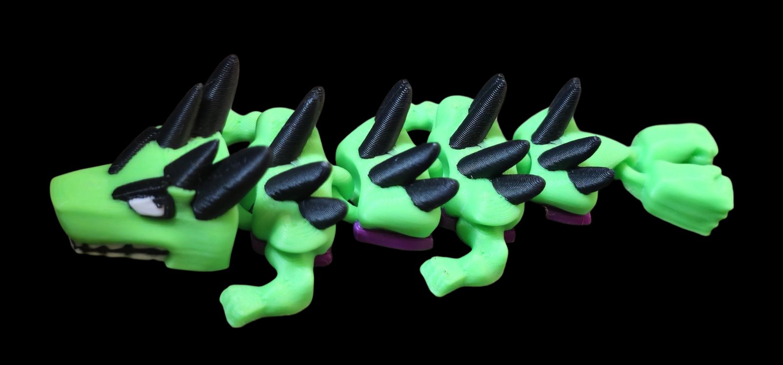 Green articulated Hulk dragon with black spikes, purple shorts and a fist tail