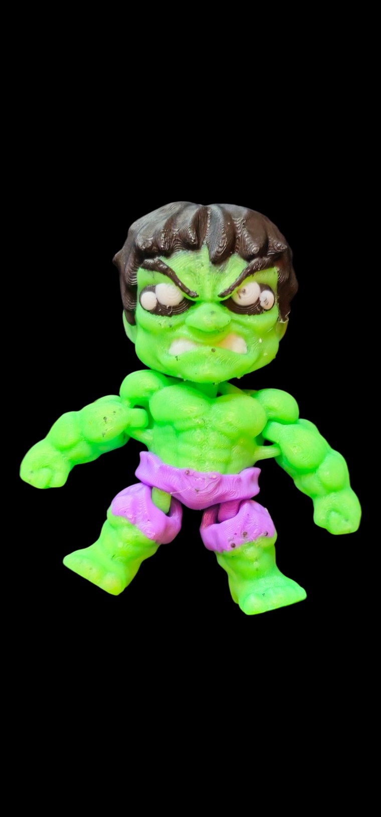 Small articulated glow-in-the-dark Hulk figure with dark hair and purple shorts