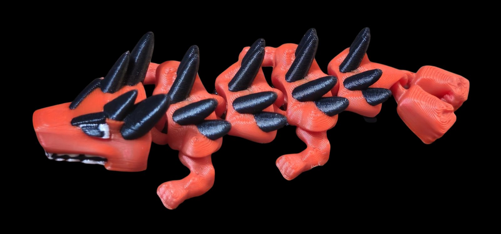 Red-orange articulated Red Hulk dragon with black spikes and a fist tail