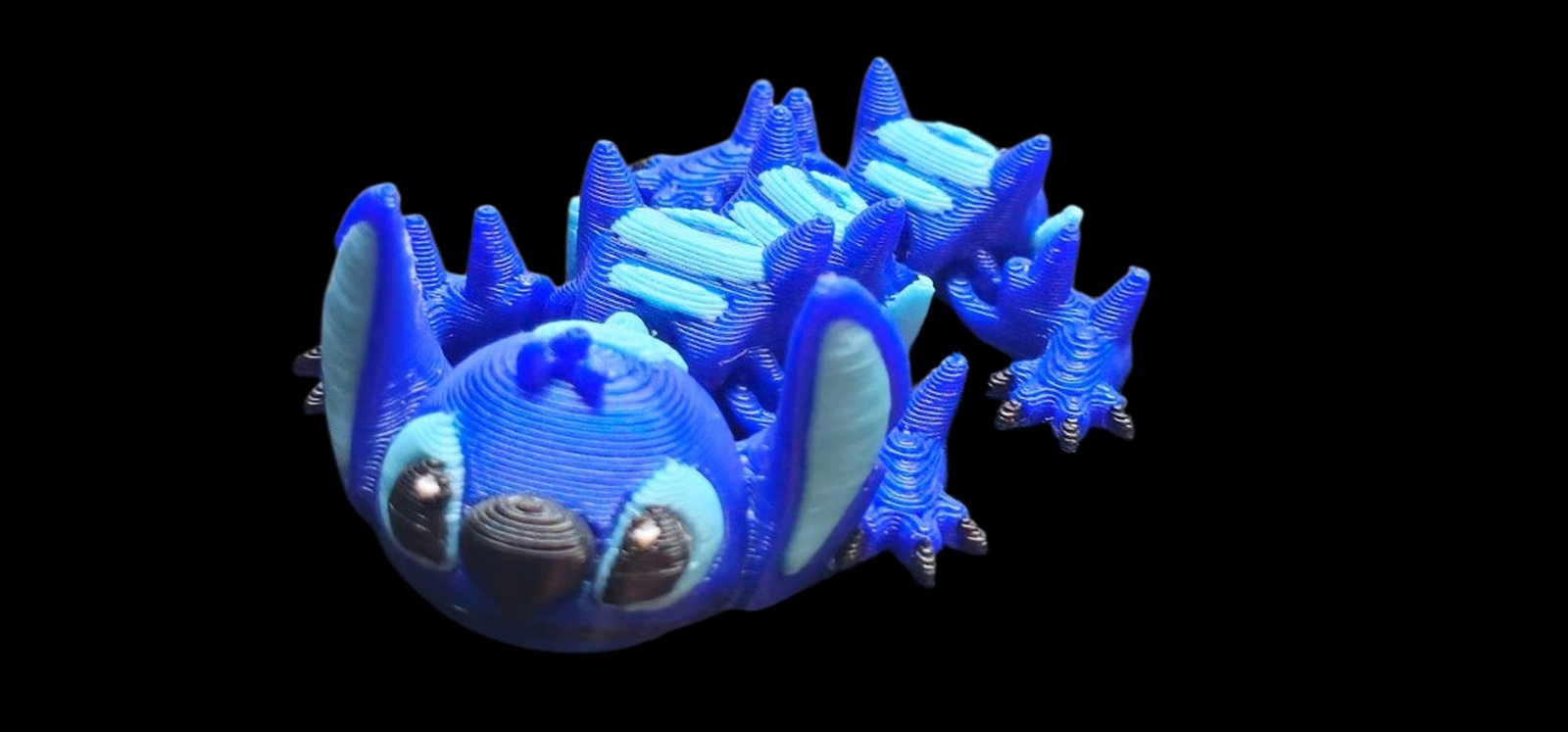Blue articulated Stitch dragon with big ears and a round Stitch face