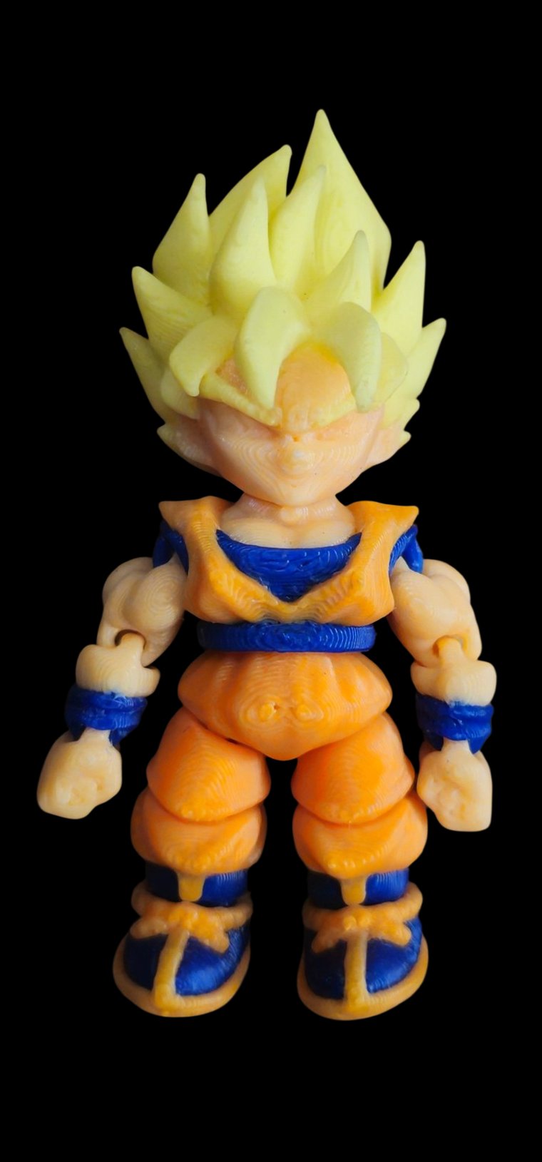Mini Super Saiyan Goku figure with golden spiky hair and an orange gi
