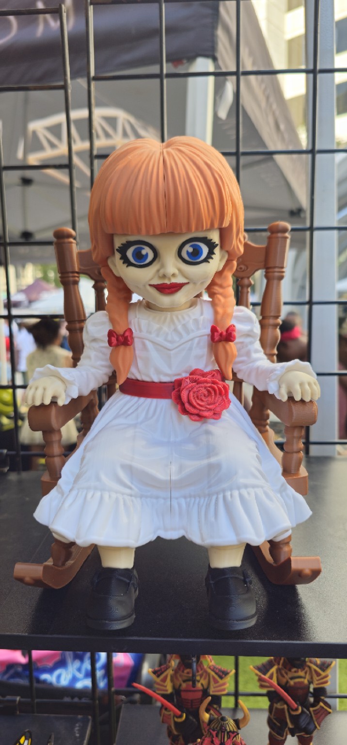 Annabelle doll inspired 3D printed figure in a white dress and rocking chair